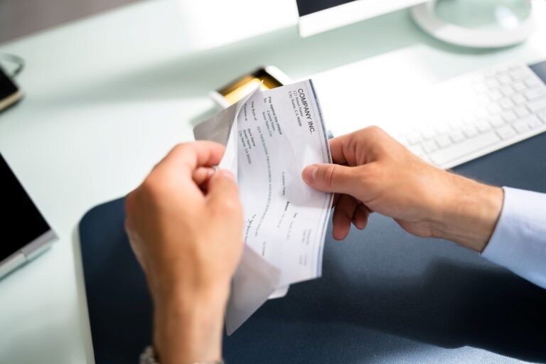 Man opening paycheck to find error